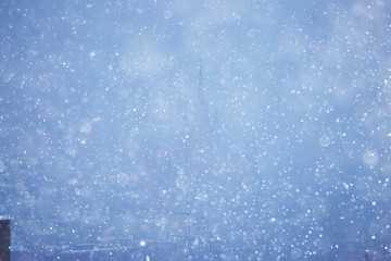 snow in a night city skyscrapers / seasonal landscape winter city, snowfall against a background of skyscrapers