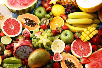 Tropical fruits background, many colorful ripe fresh tropical fruits