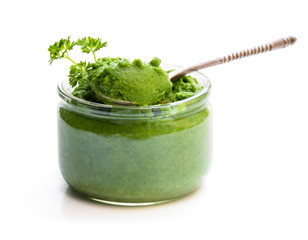 Green puree in glass jar isolated on white