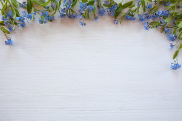 Forget-me-nots on a wooden background