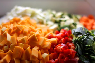 Various chopped vegetables: butternut squash, cabbage, red pepper, courgette, leek and carrot. Top...