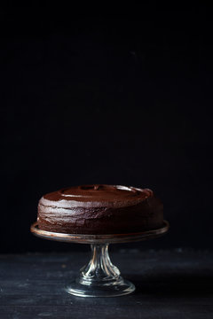 Dark chocolate devil's food cake on a glass cake plate