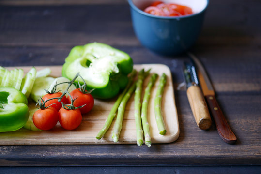 Close up of green and red vegetables on cutting board