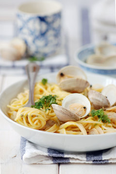 Bowl of spaghetti with whole clams and parsley