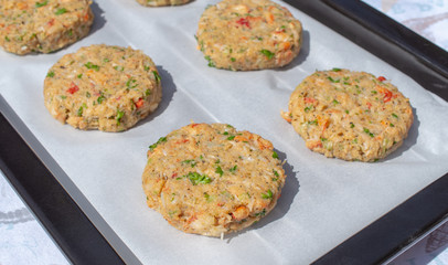 Best fish cakes raw uncooked on  baking tray. .Row of crab patties.