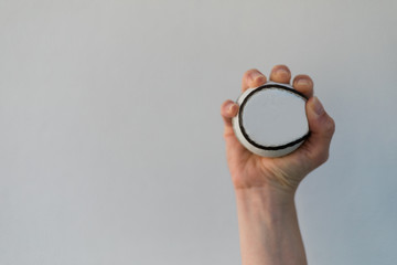 Hand holding sliotar isolated