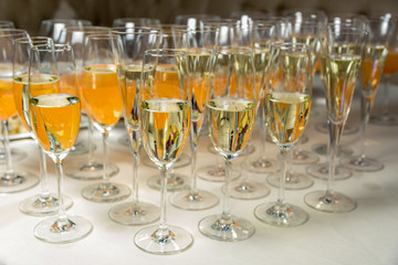 many glasses of champagne are on the table. Horizontal frame