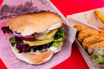 Vegan burger and soy nuggets from a food truck on a street food festival
