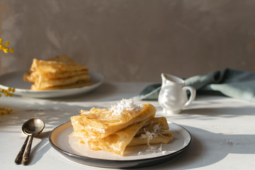 Morning, breakfast - traditional russian blini pancakes, french crepes whipped cream, mimosa flower