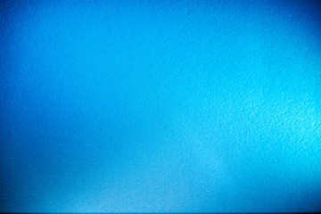 Textural monotonous blue background with the transition to blur