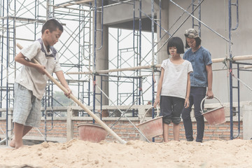 Children working at construction site for world day against child labour concept: