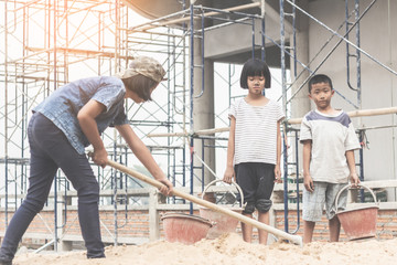 Children working at construction site for world day against child labour concept: