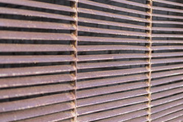 Old rusty louvered grill.