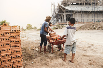 Children working at construction site for world day against child labour concept: