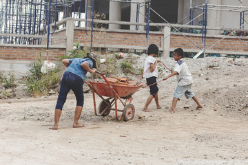 Children working at construction site for world day against child labour concept: