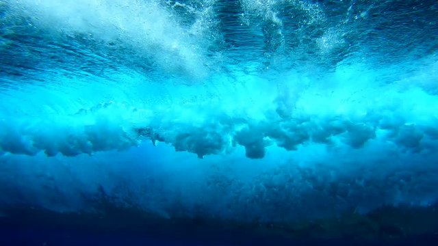 Underwater view of the crystal clear barelling wave