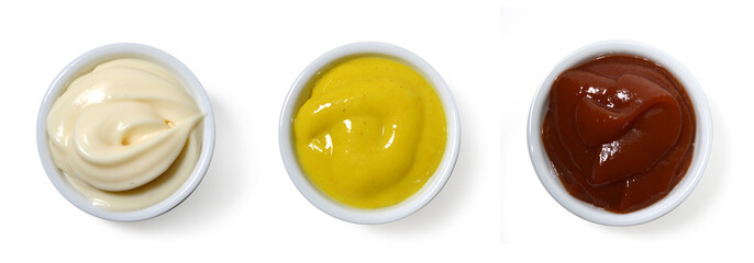 Sauces. Mayonnaise, Catchup and mustard in small porcelain containers viewed from above.