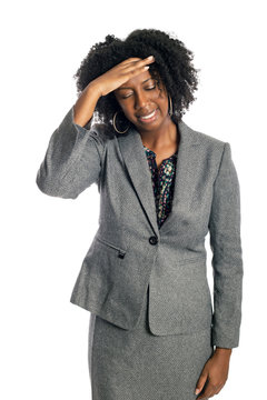 Black African American female businesswoman isolated on a white background in pain from a headache
