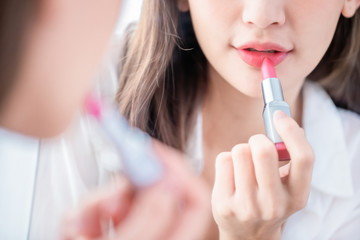 woman applying lipstick