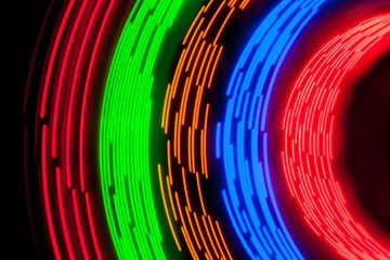 Trayectorias circulares formadas por LEDS de colores que se encienden y apagan al ritmo de diferentes patrones digitales.