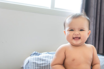 Happy and smiling baby girl after shower