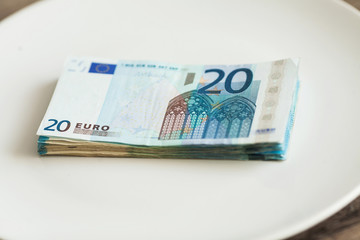 Money lying on the plate. Euros photo. Greedy corruption concept. Bribe idea.