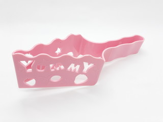 Colorful Pink Plastic cake cutter in White Isolated Background 
