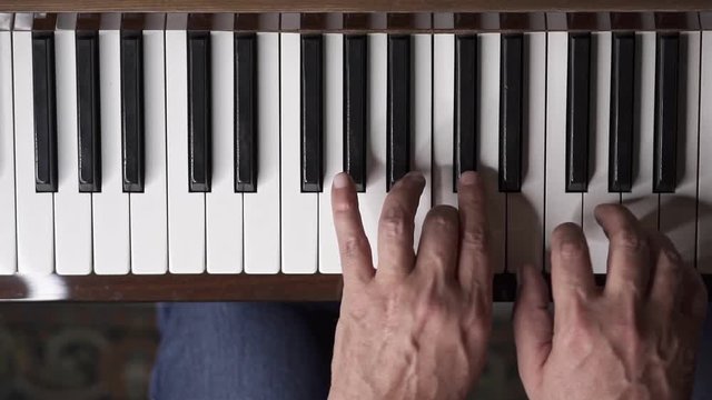 Musician plays piano, Slow Motion Top View Medium shot with shallow depth of field
