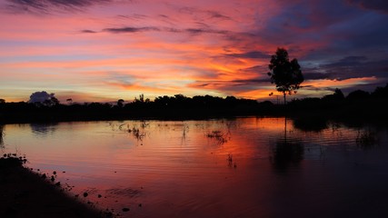 Fototapeta na wymiar Stunning colors of sunset skylight reflected in a lake