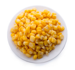 Corn on a white plate isolated on white. Top view.