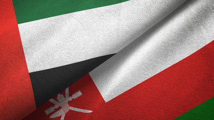 United Arab Emirates and Oman two flags textile cloth, fabric texture