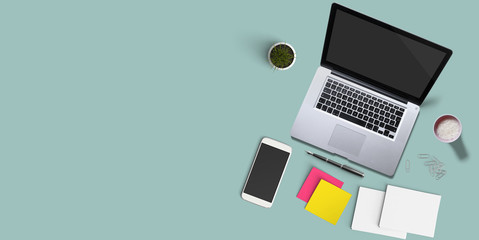 Office workplace with laptop, notebook, office supplies and stationery on turquoise background. Solution, business planning, creative, design, learning, start up or working flat lay top view concept.