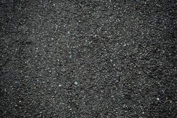 Black asphalt rough ground texture background, wallpaper