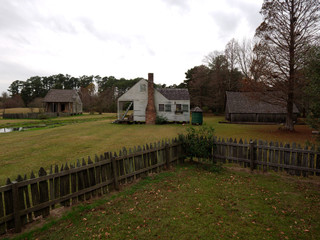 Fototapeta na wymiar Cabin and barn at LSU Rural Life Museum, an outdoor museum of Louisiana history, Baton Rouge, Louisiana, USA