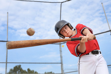 Young batter hitting the ball in a youth Baseball game
