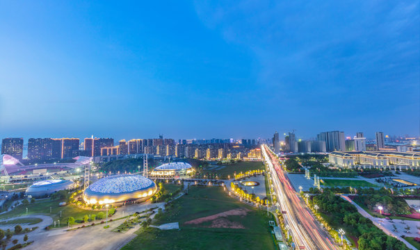 Night falls on city buildings and street scenery. Jiujiang City, China