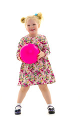 Little girl is playing with a ball