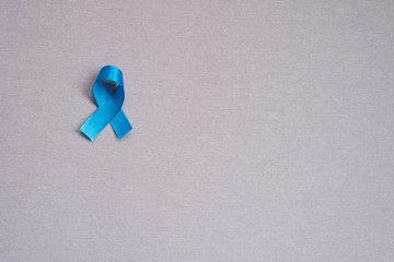 Blue ribbon, symbol of rectal cancer. Cancer awareness month. Concept of health.