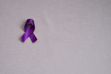 Purple ribbon, symbol of testicular cancer. Cancer awareness month. Concept of health.