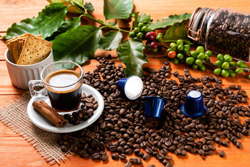 Glass of clear glass of hot coffee on wooden table. Orange wood pinus.