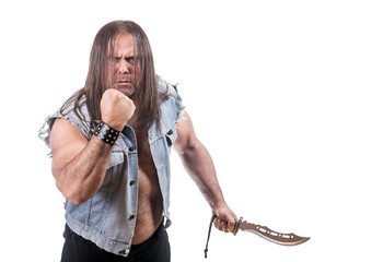 Aggressive man in jeans jacket threaten with fist and knife, isolated on white background.