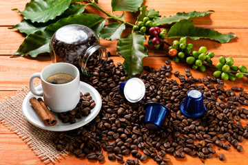 White cup of hot coffee on wooden table. Orange wood pinus.