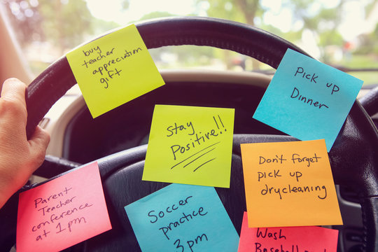 Steering wheel covered in notes as a reminder of errands to do