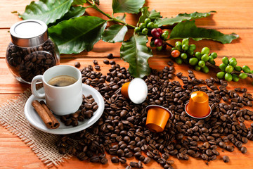White cup of hot coffee on wooden table. Orange wood pinus.