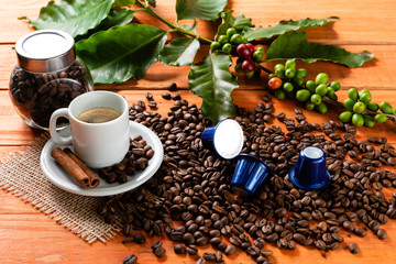 White cup of hot coffee on wooden table. Orange wood pinus.