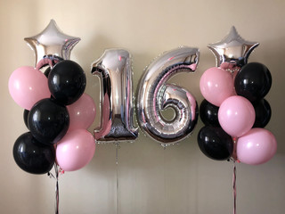 Composition of helium balloons black, pink, as well as a silver star and a large figure of sixteen silver colors. Gift for 16 years for a girl