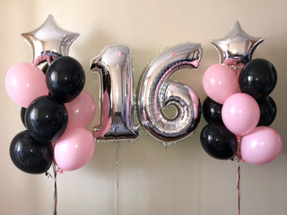 Composition of helium balloons black, pink, as well as a silver star and a large figure of sixteen silver colors. Gift for 16 years for a girl