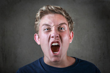 Angry young teenager yelling
