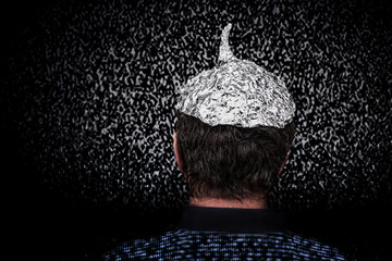 Man in a tin foil hat with digital noise