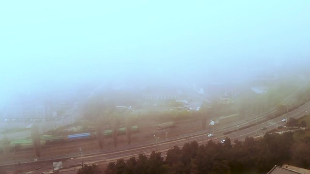 Lift down up aerial drone shot of Constanta's port dissapearing in the fog